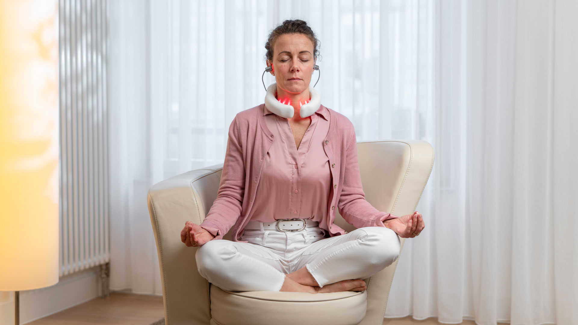 LumoHome Patientenstimmen Frau nutzt das LumoHome Lasertherapiegerät während einer entspannten Meditation